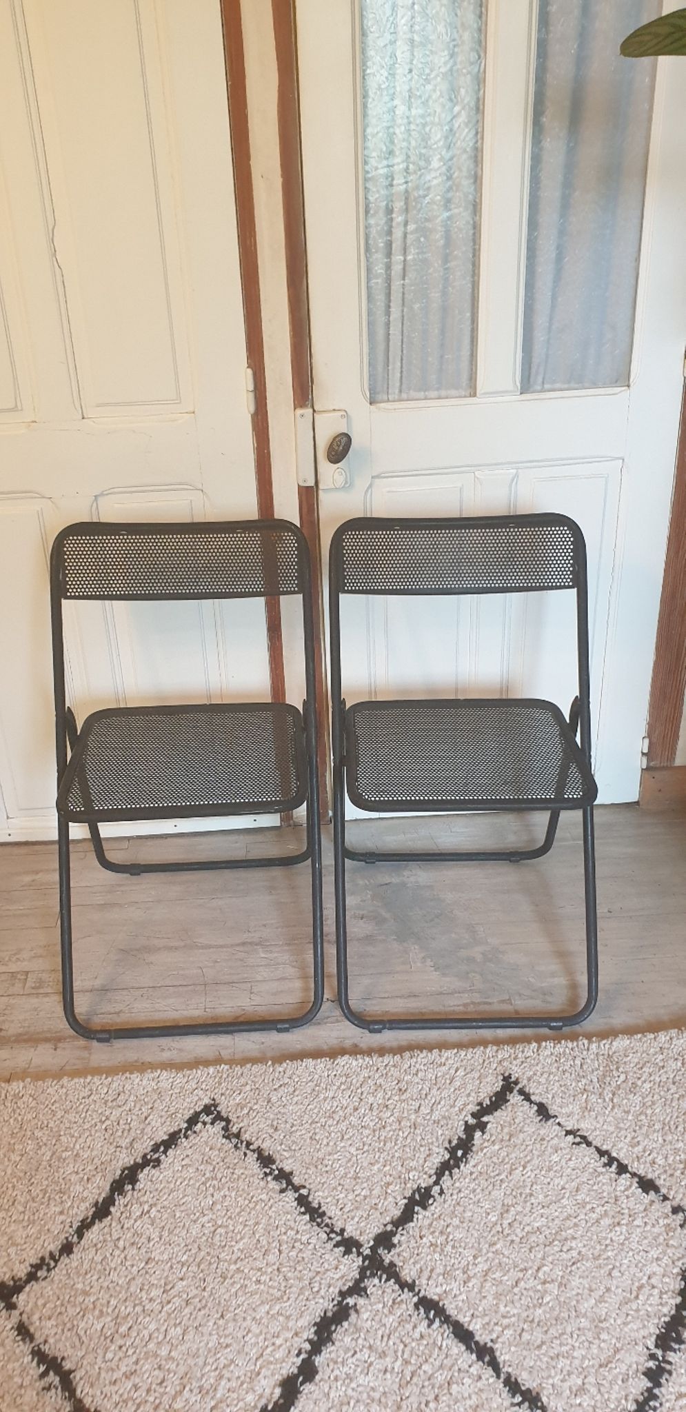 Pair of folding chairs in perforated metal