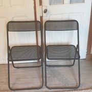Pair of folding chairs in perforated metal