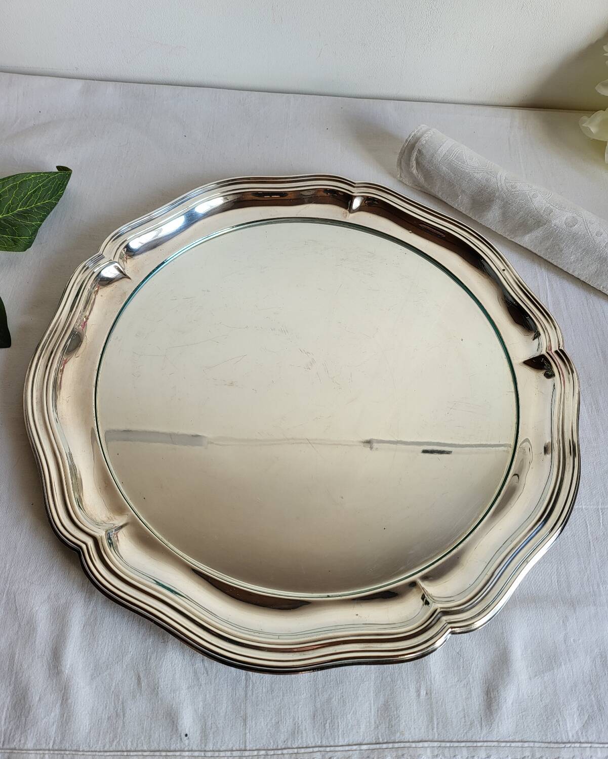 Round silver-plated serving dish with a glass base.