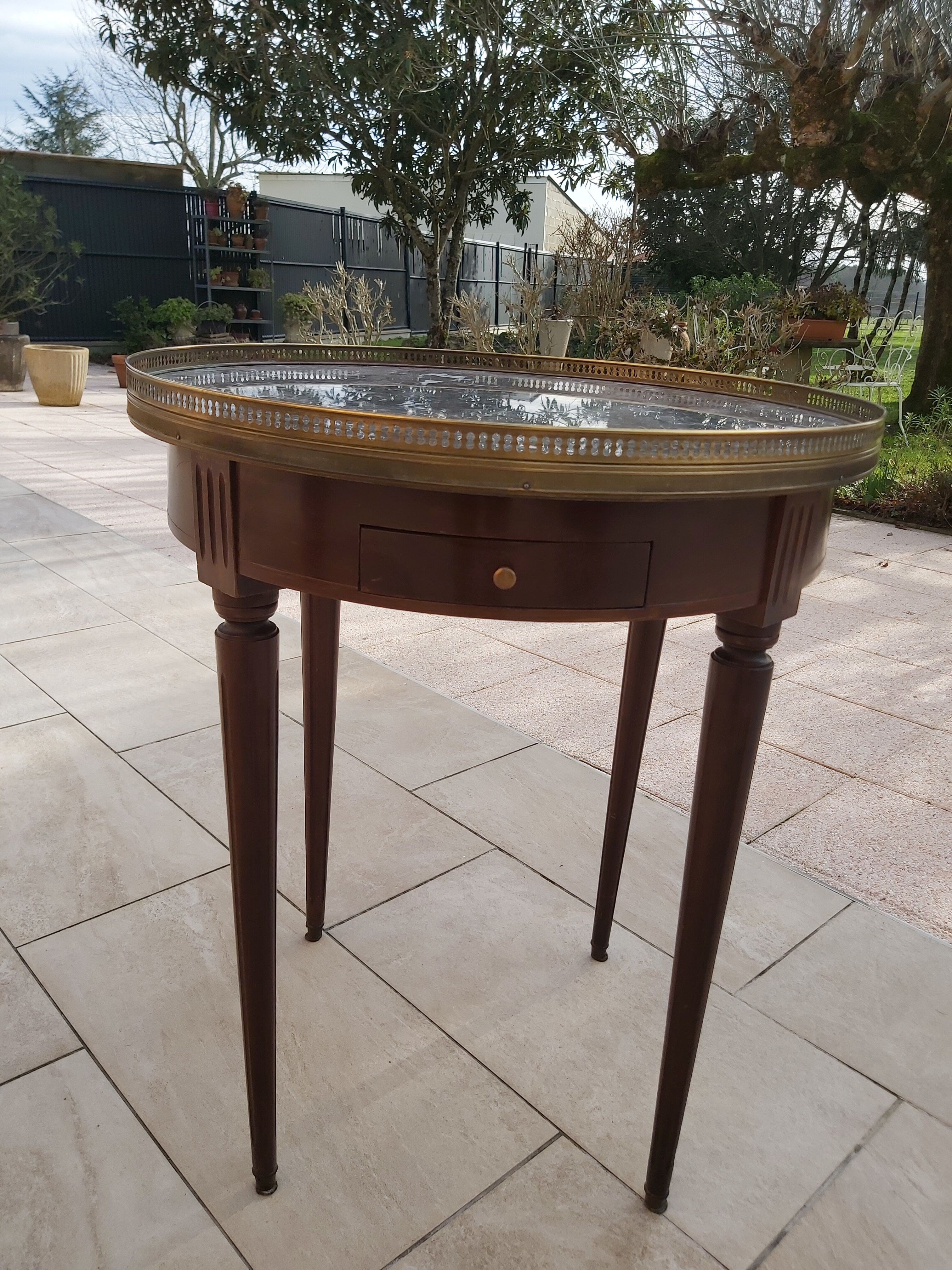 Gray marble mahogany pedestal table and brass gallery