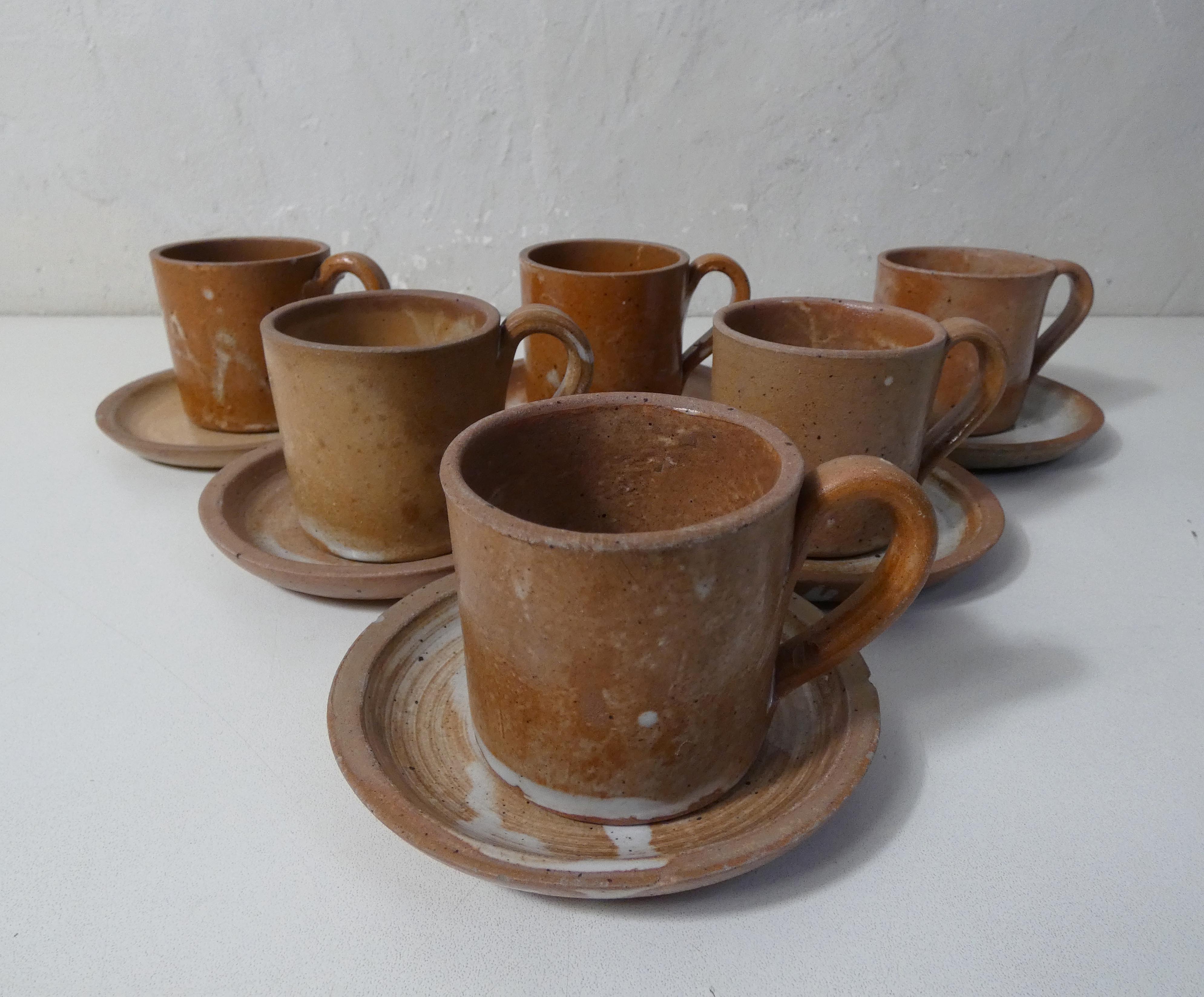6 stoneware cups and saucers