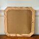 Octagonal mirror in light wood with grooves.