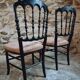 Pair of antique Napoleon III chairs in blackened wood and fabric.
