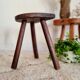 Old wooden tripod wooden farm stool made of wood