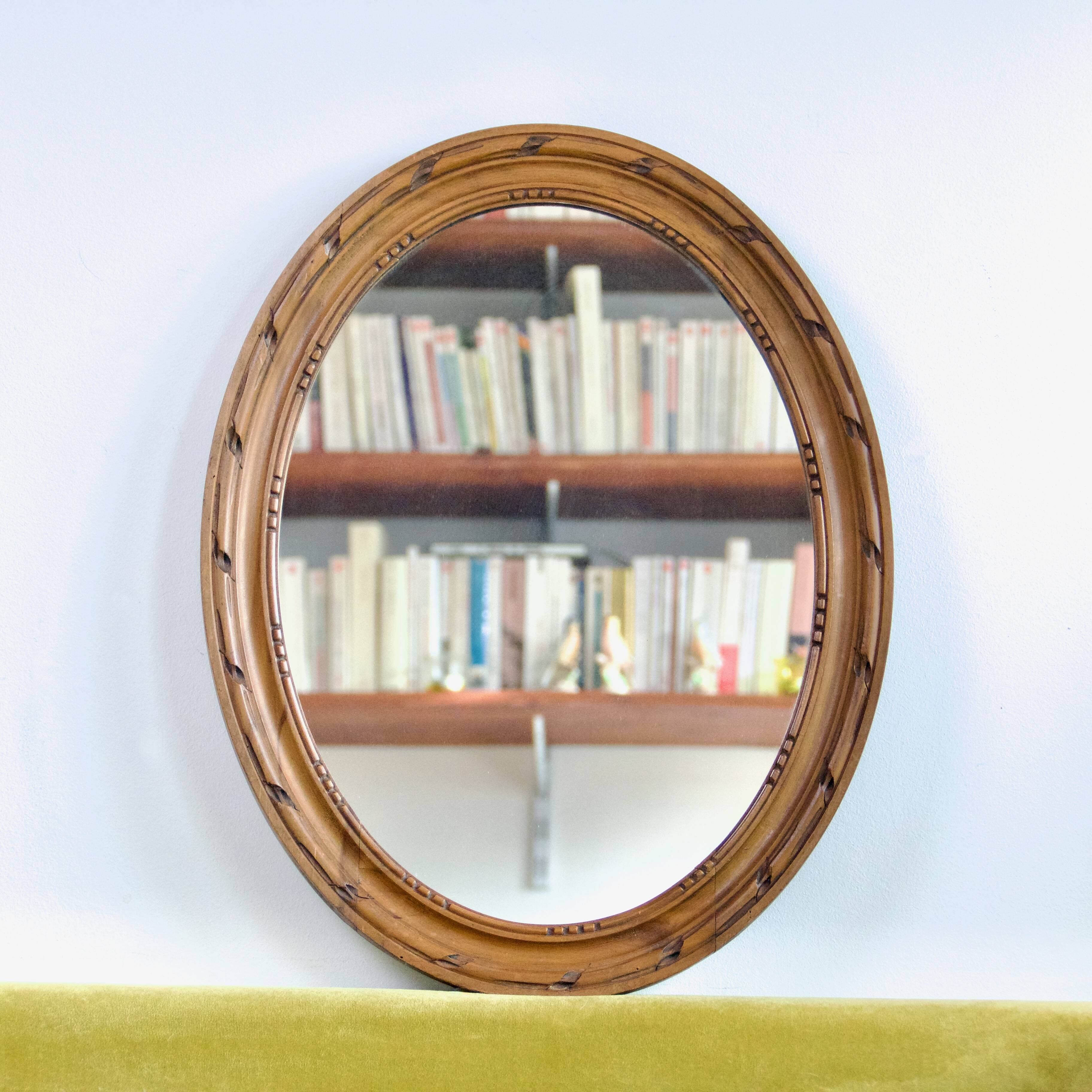 Antique oval mirror in carved wood