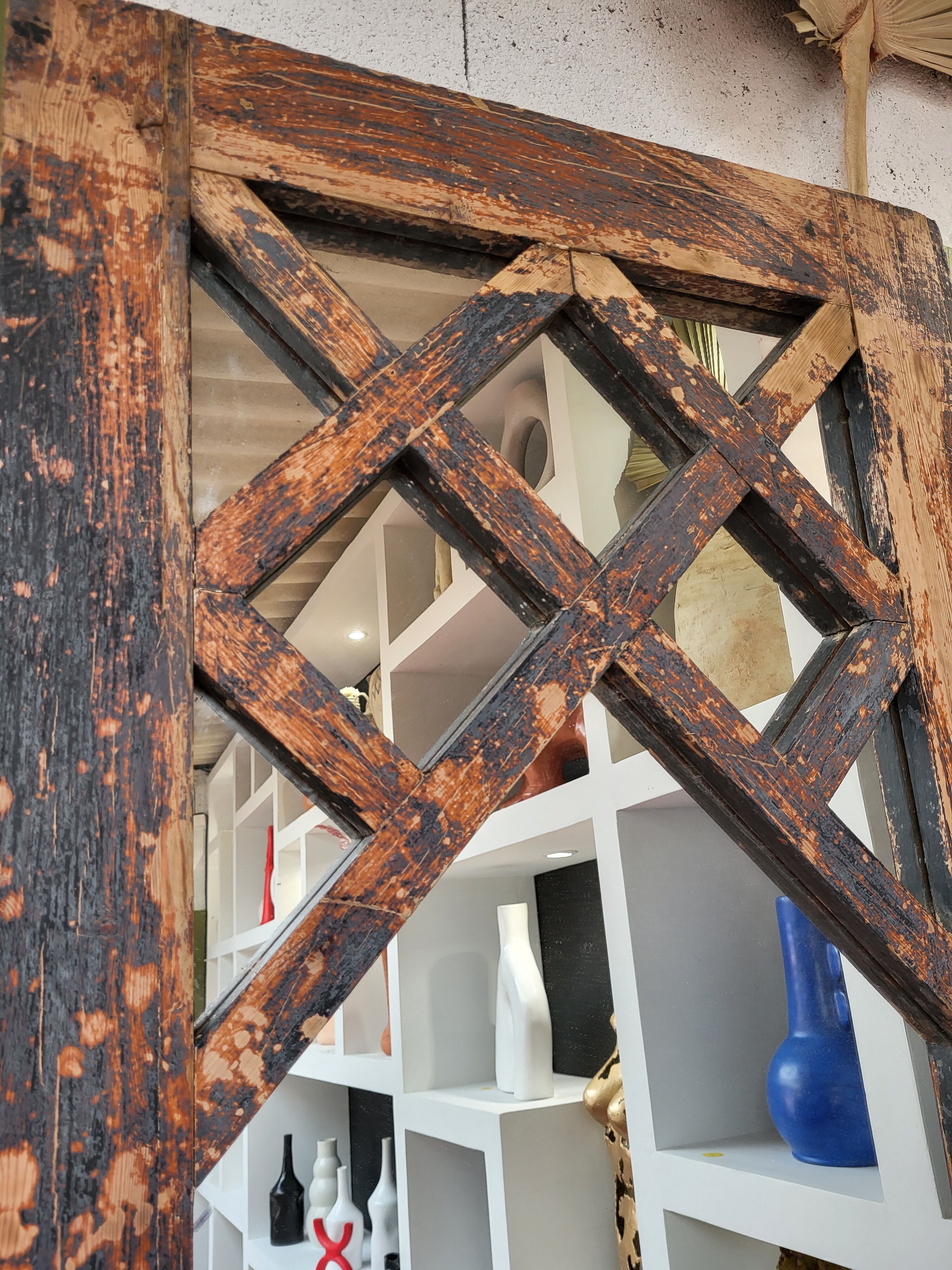 Wooden mirror mounted on old door