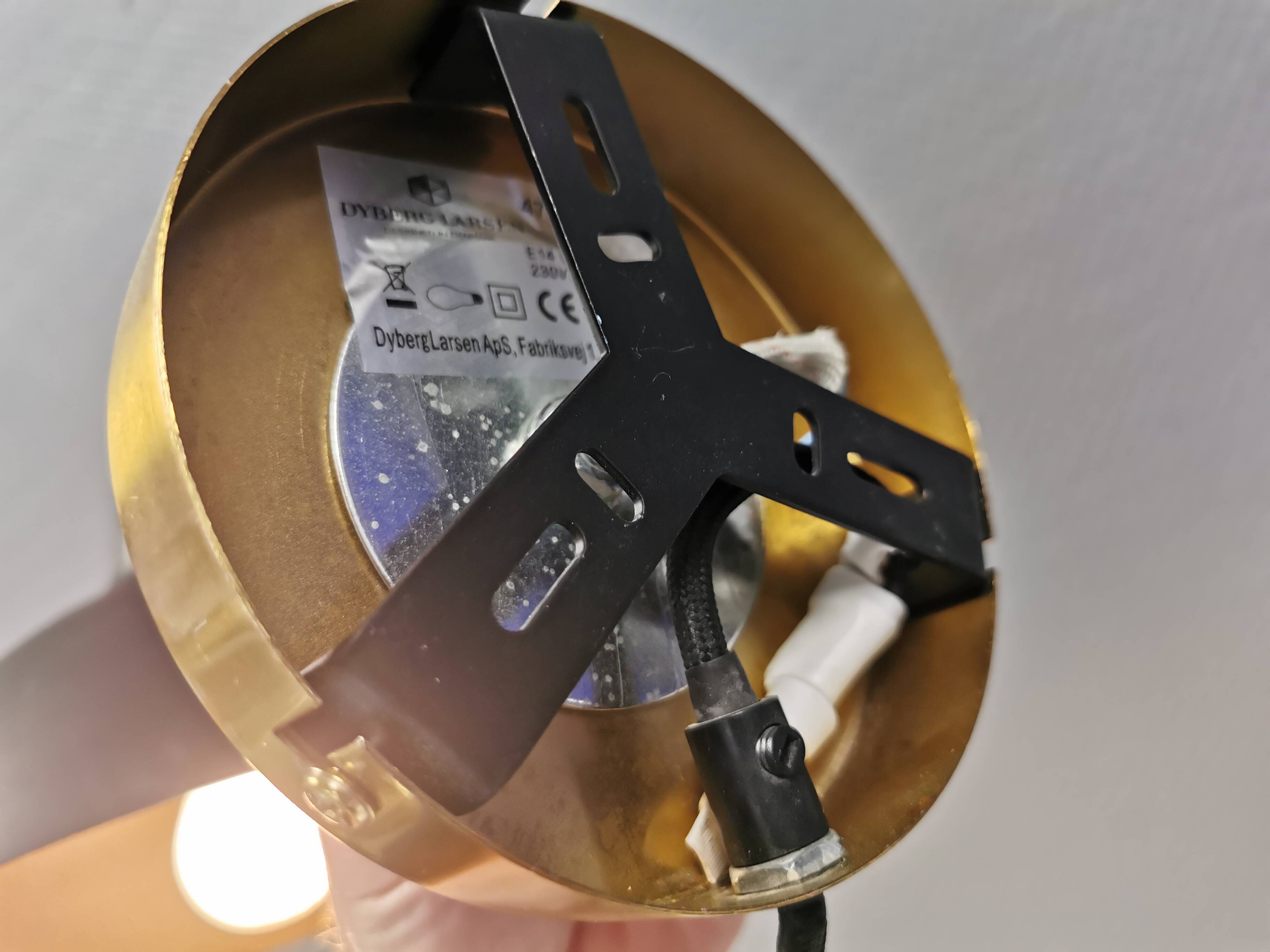 A wall lamp in black and brass-coloured finishes. Danish, early 2000s.