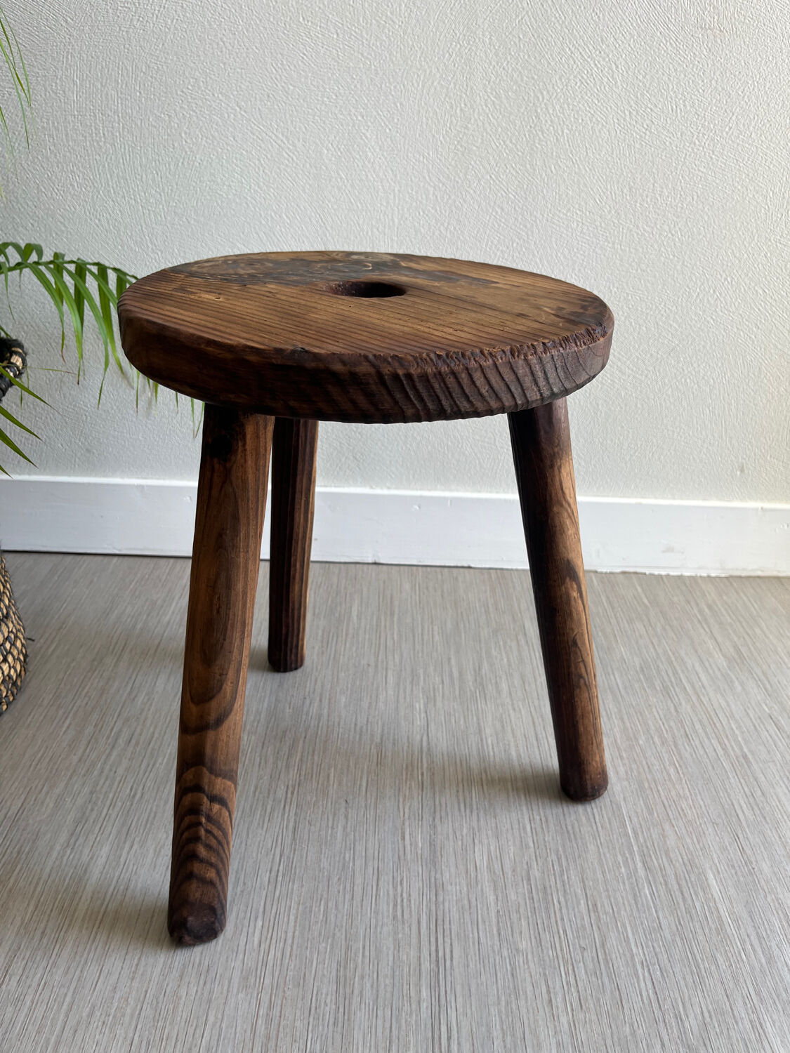Three-legged wooden stool