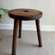 Three-legged wooden stool