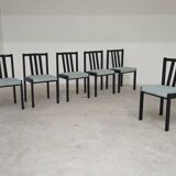 Set of 6 modernist black chairs with light blue-green ribbed fabric.