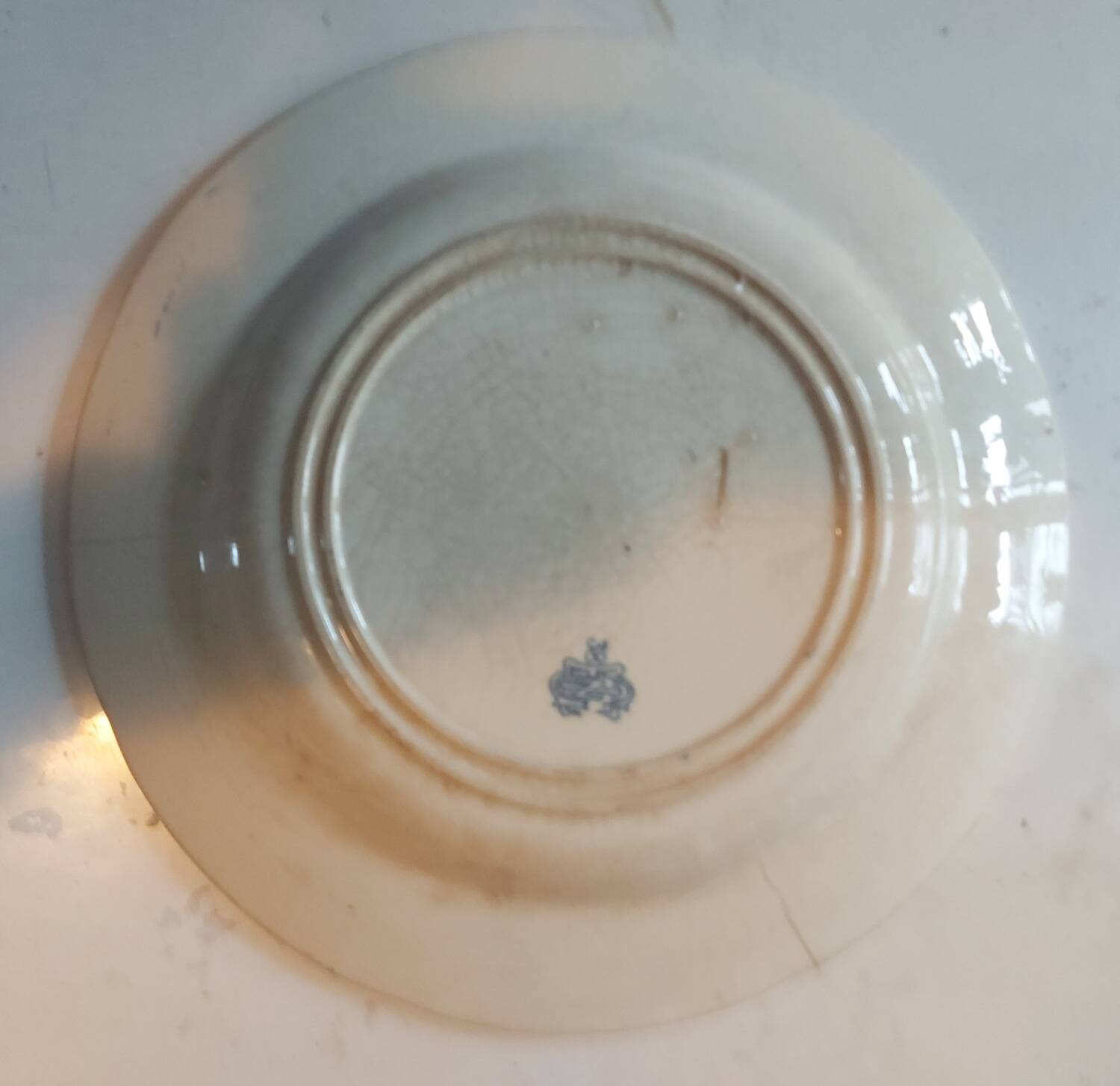 Two antique 19th-century plates, one flat and one deep, from Gien.