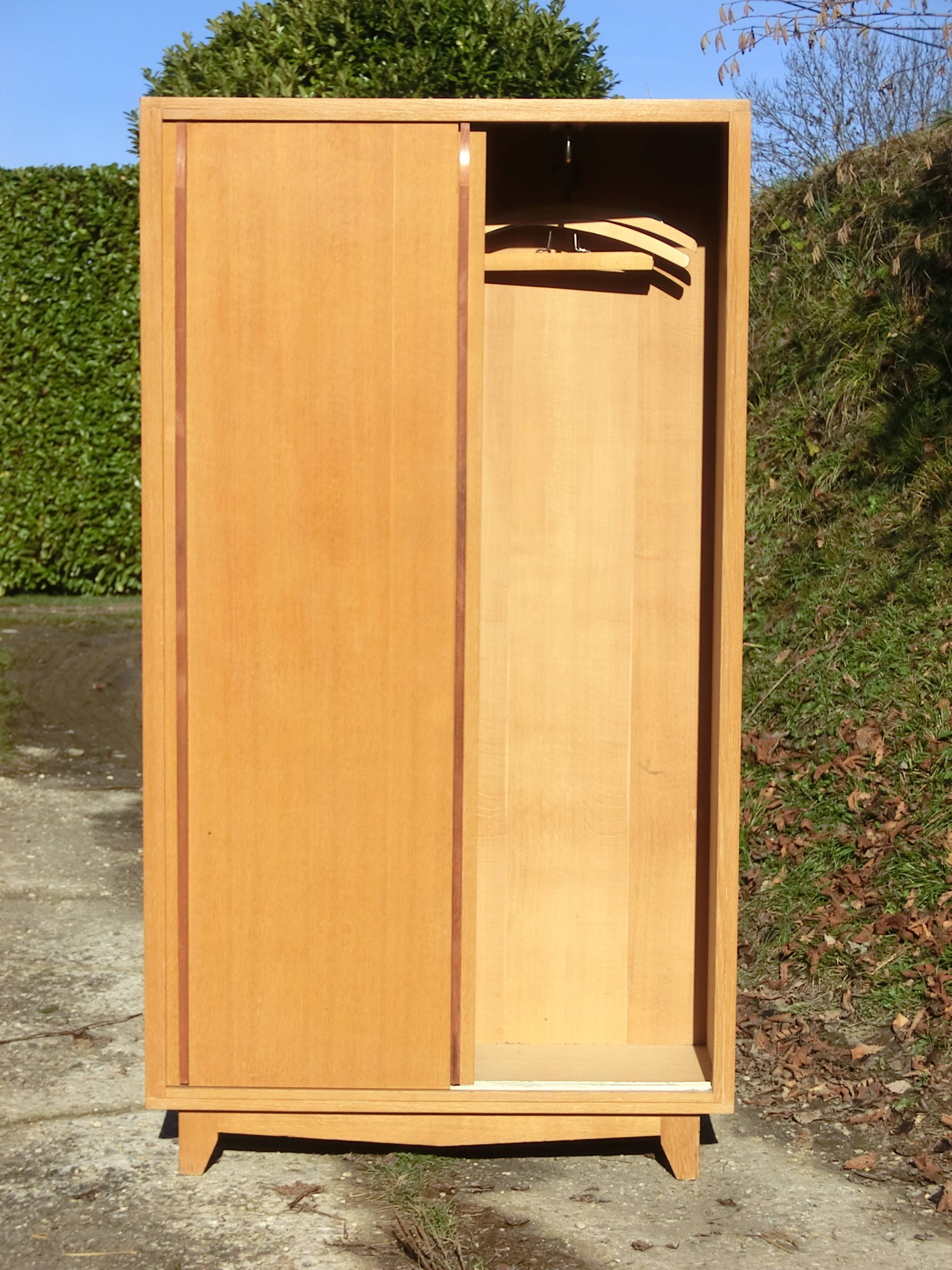 Small Scandinavian wardrobe with sliding doors - 1 side for hanging clothes.