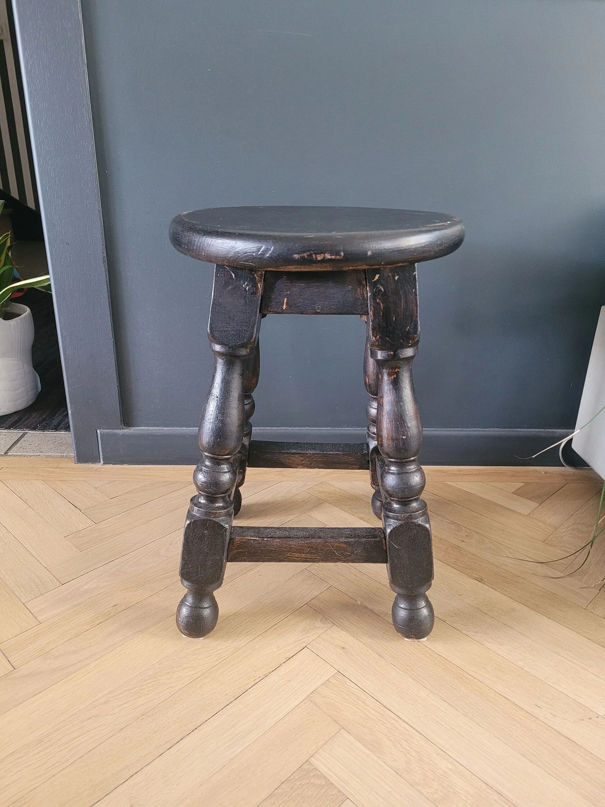 Antique wooden stool with turned legs.