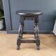 Antique wooden stool with turned legs.