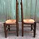 Duo of vintage rustic straw straw chairs in oak.
