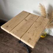 Bistro table with a central cast iron base in industrial style.