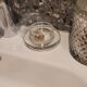 2 transparent glass butter dishes with their matching cloches.