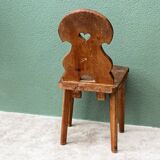 Old Swiss escabelle chair in carved wood