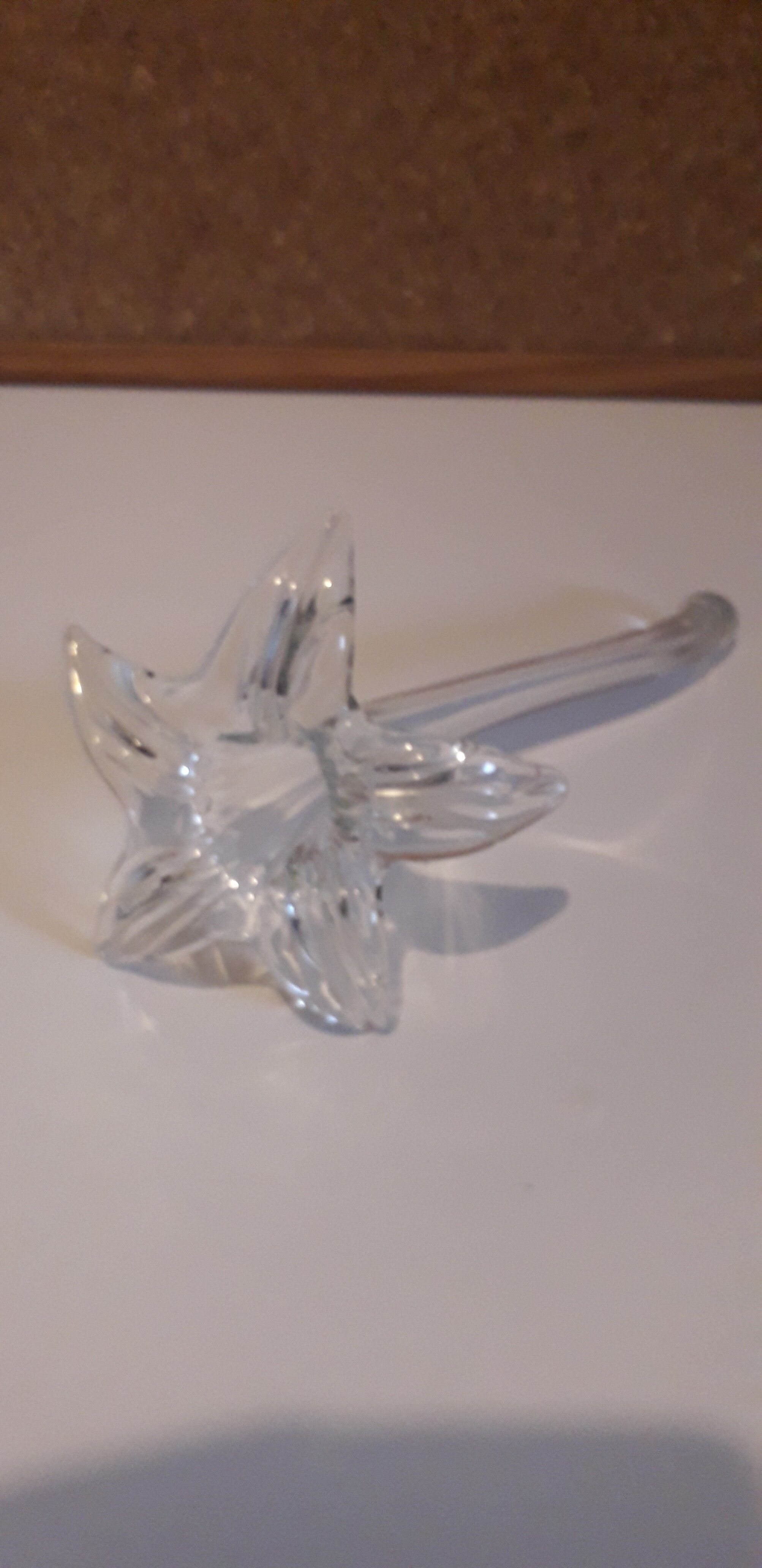 Glass soliflore vase in the shape of a fleur-de-lis on metal base