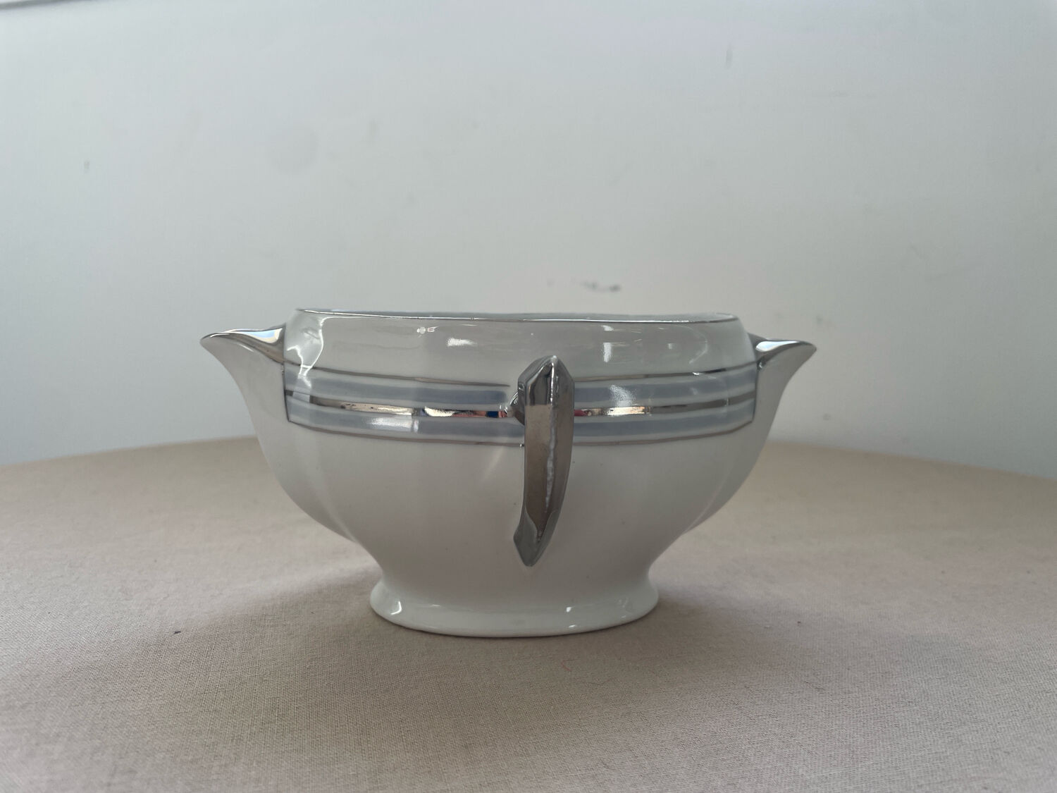 Antique white French porcelain sauce boat M&S with silver trim.