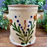 Antique ceramic pot with hand-painted floral decoration.