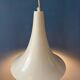 Small vintage beige pendant light in the shape of a witch's hat.
