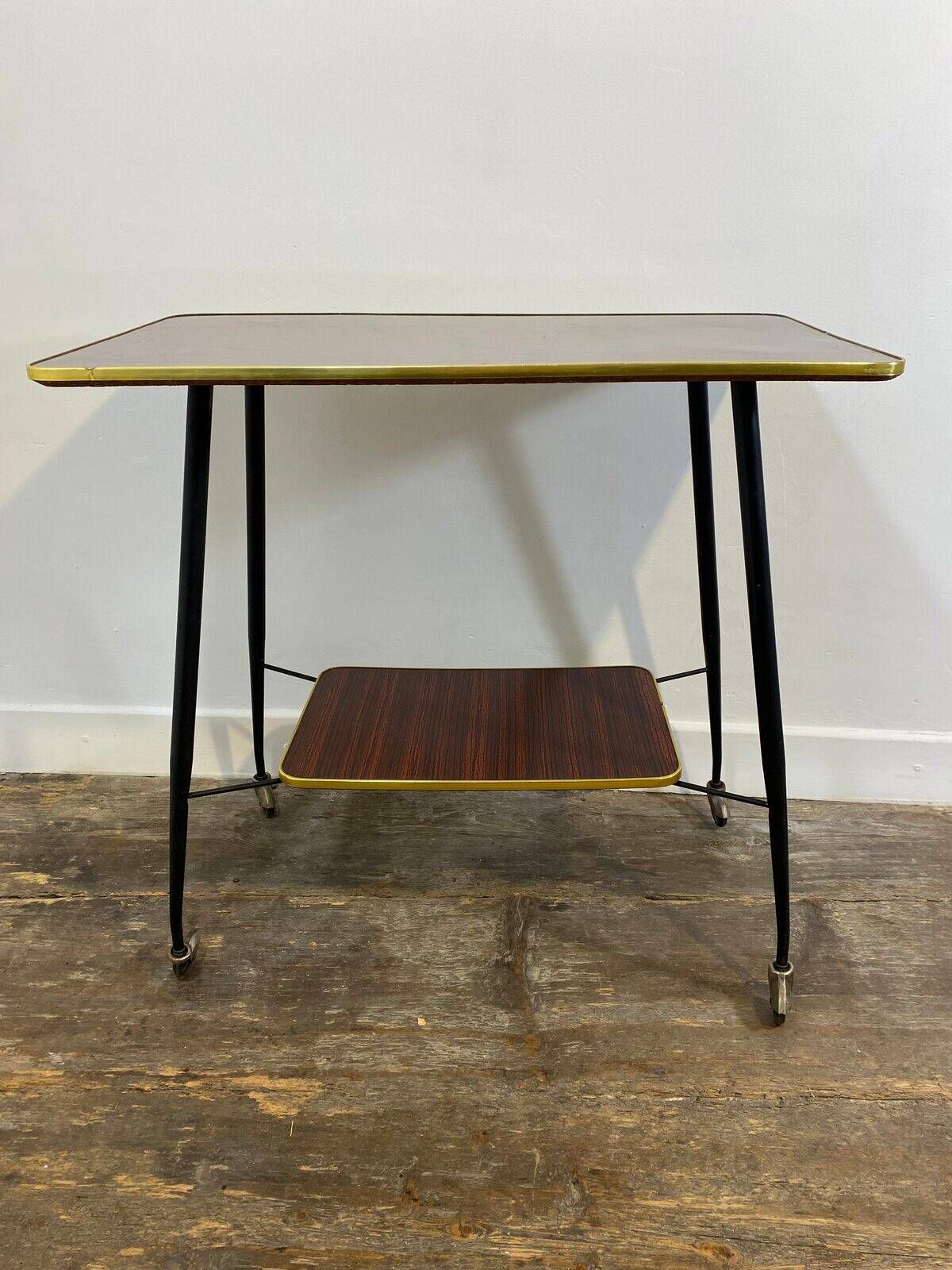 Vintage side table, brass gallery and wheels, 1950s.