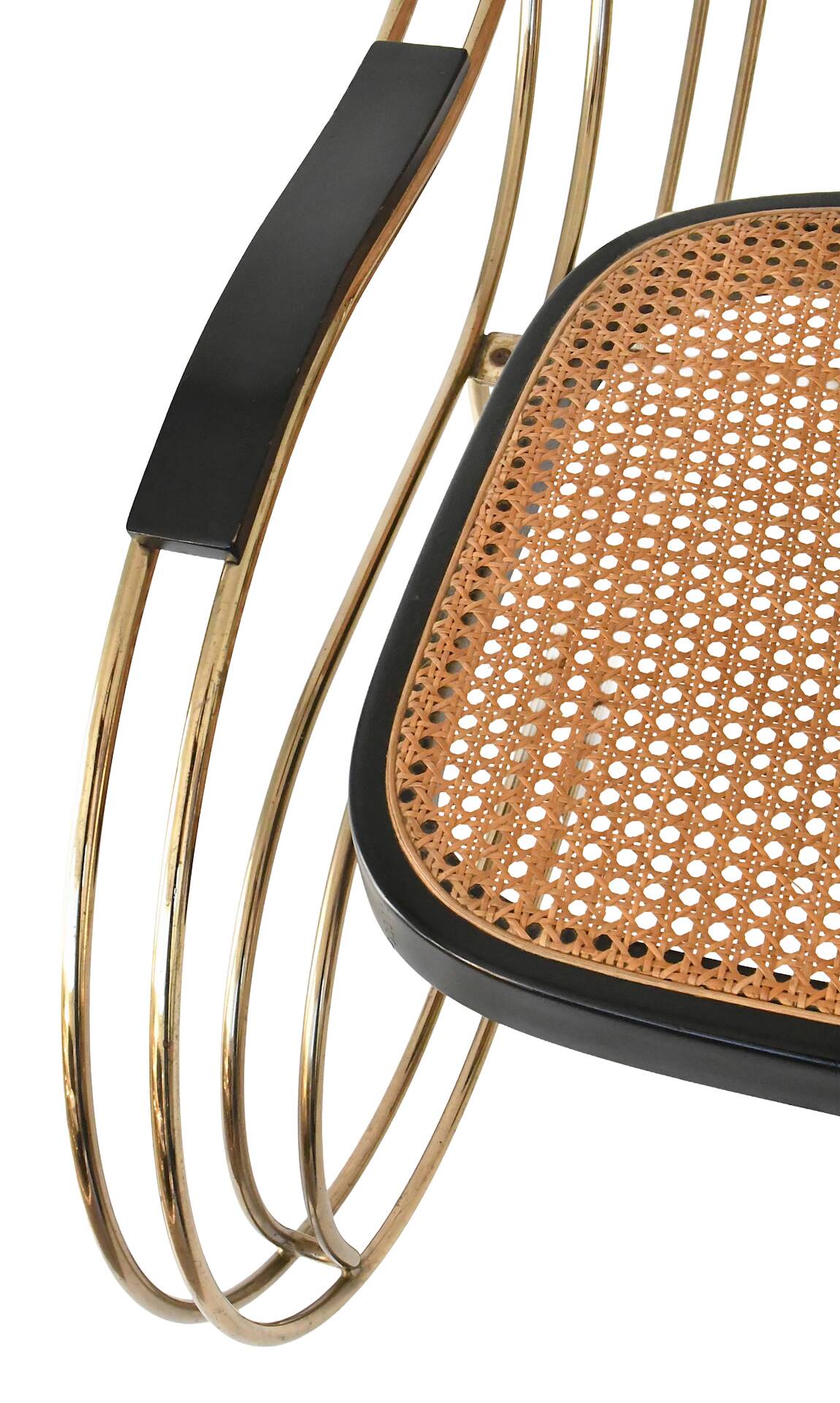 Modernist rocking chair in gilded brass and cane.