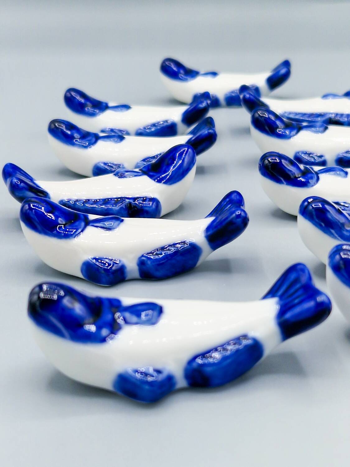 Set of 11 vintage blue and white porcelain fish knife rests.