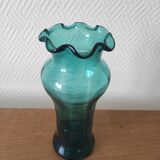 Blown glass vase with a flared neck and wavy rim.