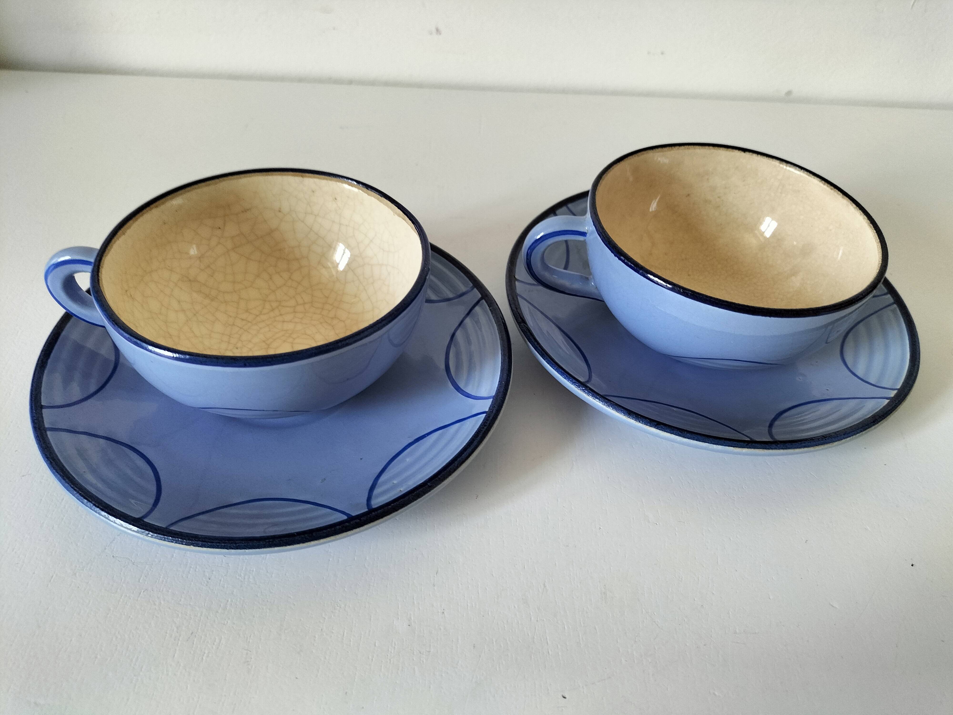 A pair of glazed ceramic cups and saucers from the 60s-70s.