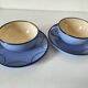 A pair of glazed ceramic cups and saucers from the 60s-70s.
