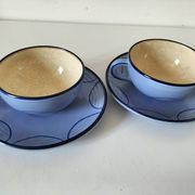 A pair of glazed ceramic cups and saucers from the 60s-70s.