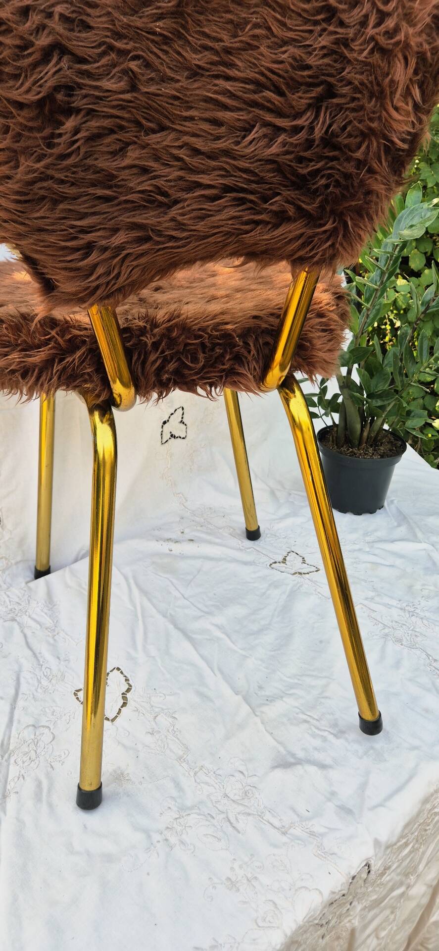 Vintage shaggy chair in faux fur with golden metal legs.