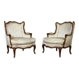 Pair of small Louis XV style wing chairs in carved walnut, Bosson stamp