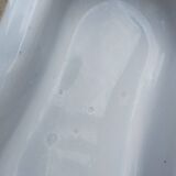 Antique bidet in enamelled sheet metal with wrought iron support