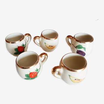5 antique cups with liquor, porcelain fruits
