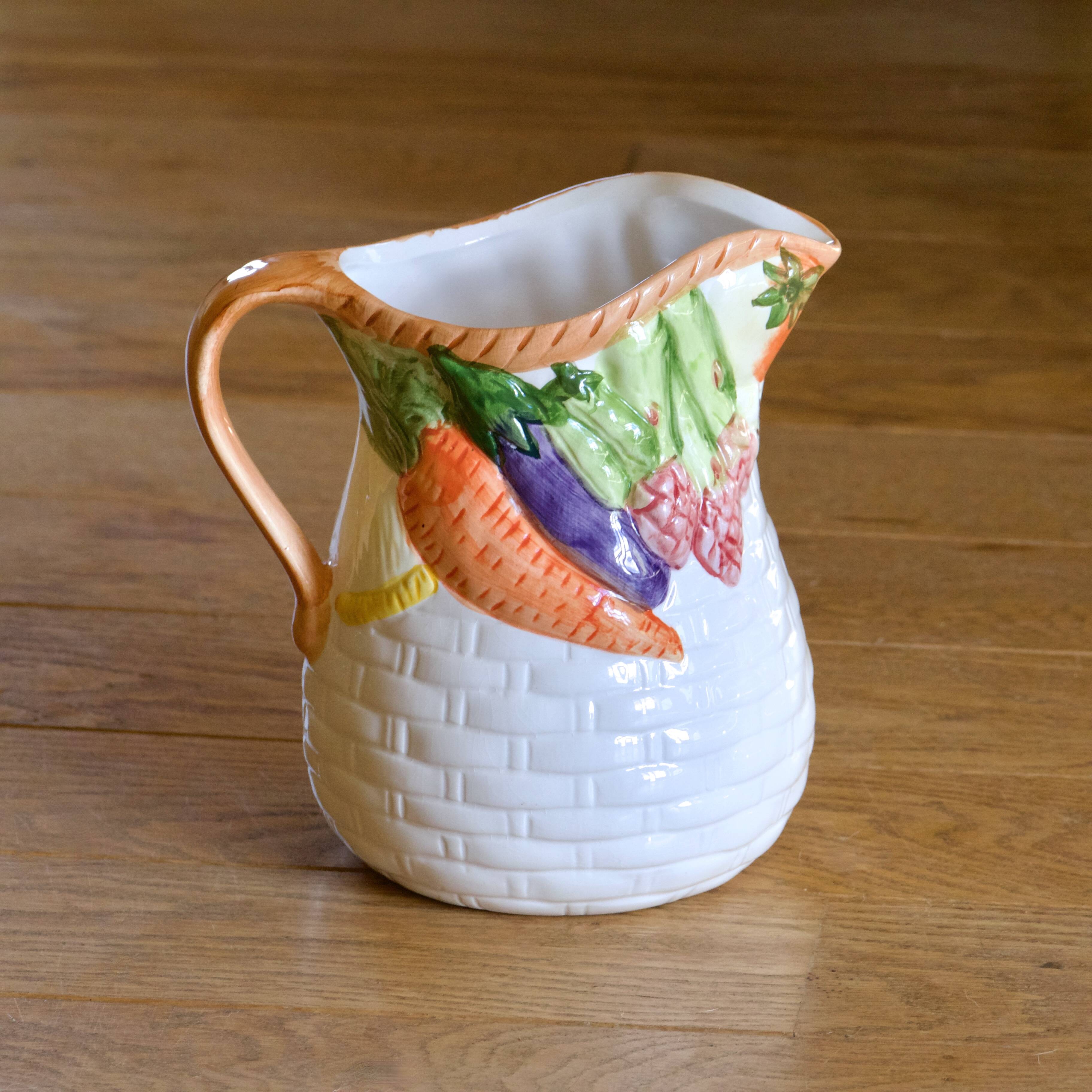 Hand-painted earthenware carafe with a raised vegetable basket design