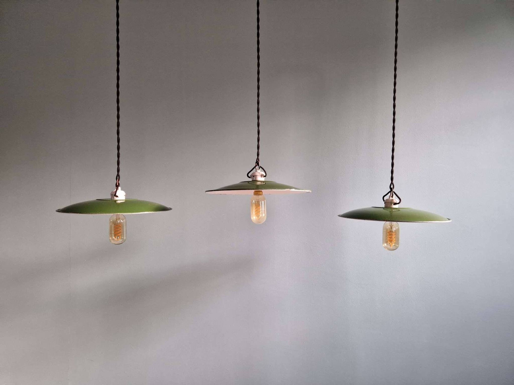 Trio of large industrial suspensions in green enamelled sheet metal.