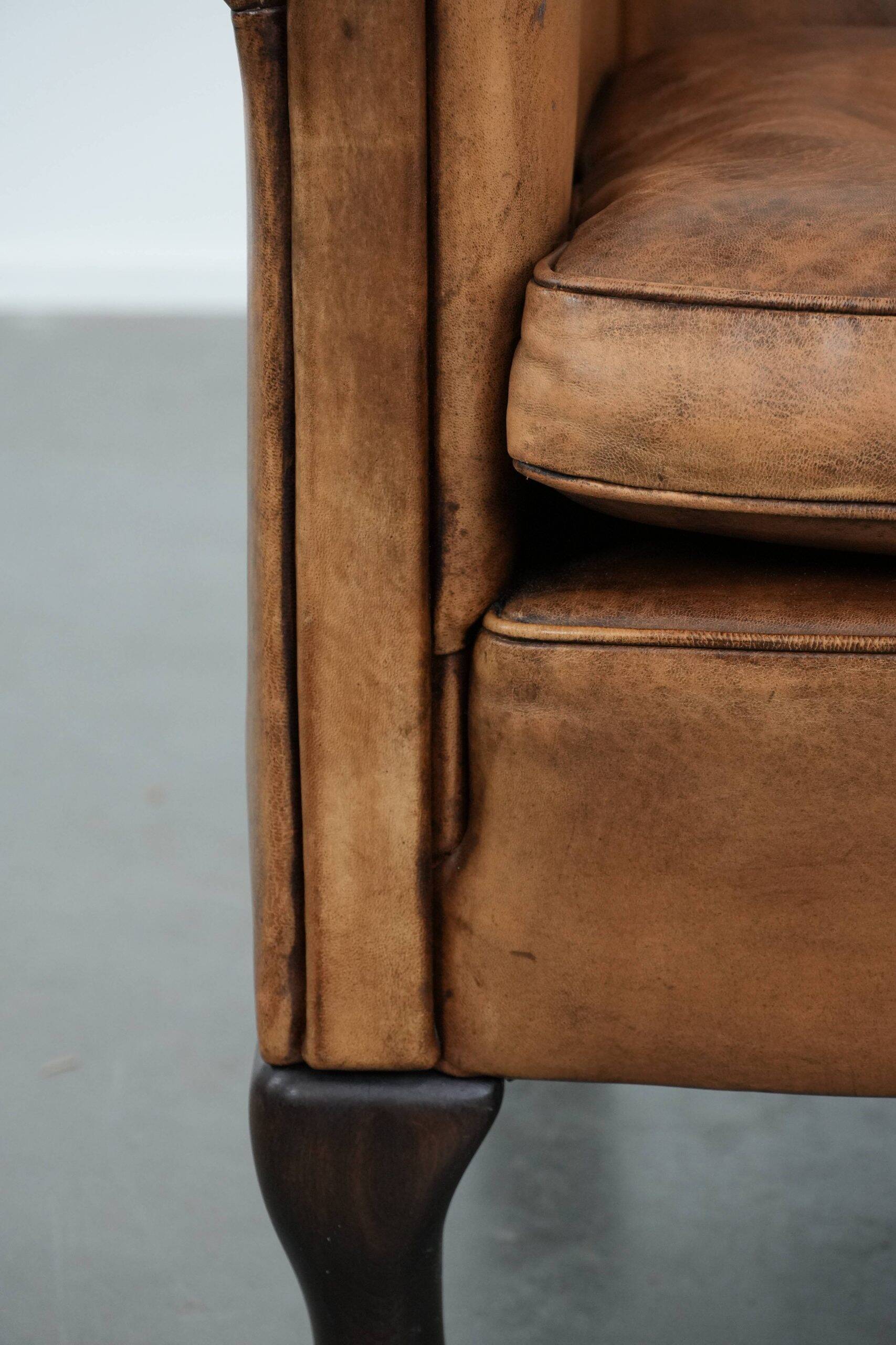 Vintage sheepskin armchair with a beautiful light colour and elegant legs
