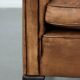 Vintage sheepskin armchair with a beautiful light colour and elegant legs