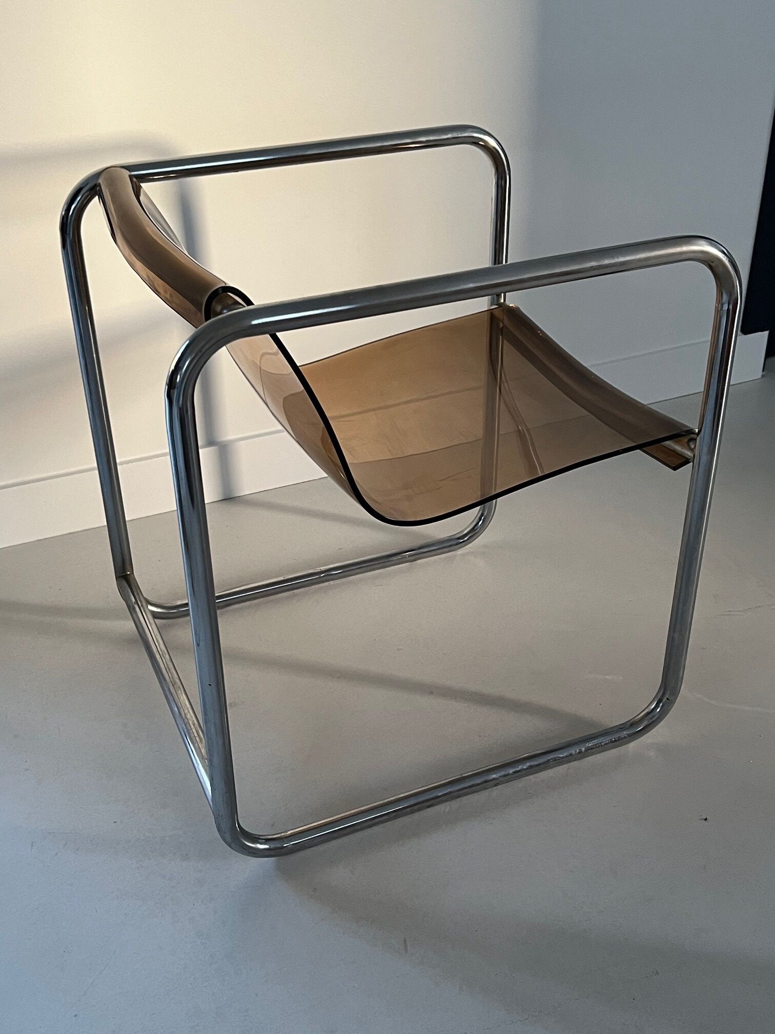 Armchair in chrome tubular metal and smoked plexiglass