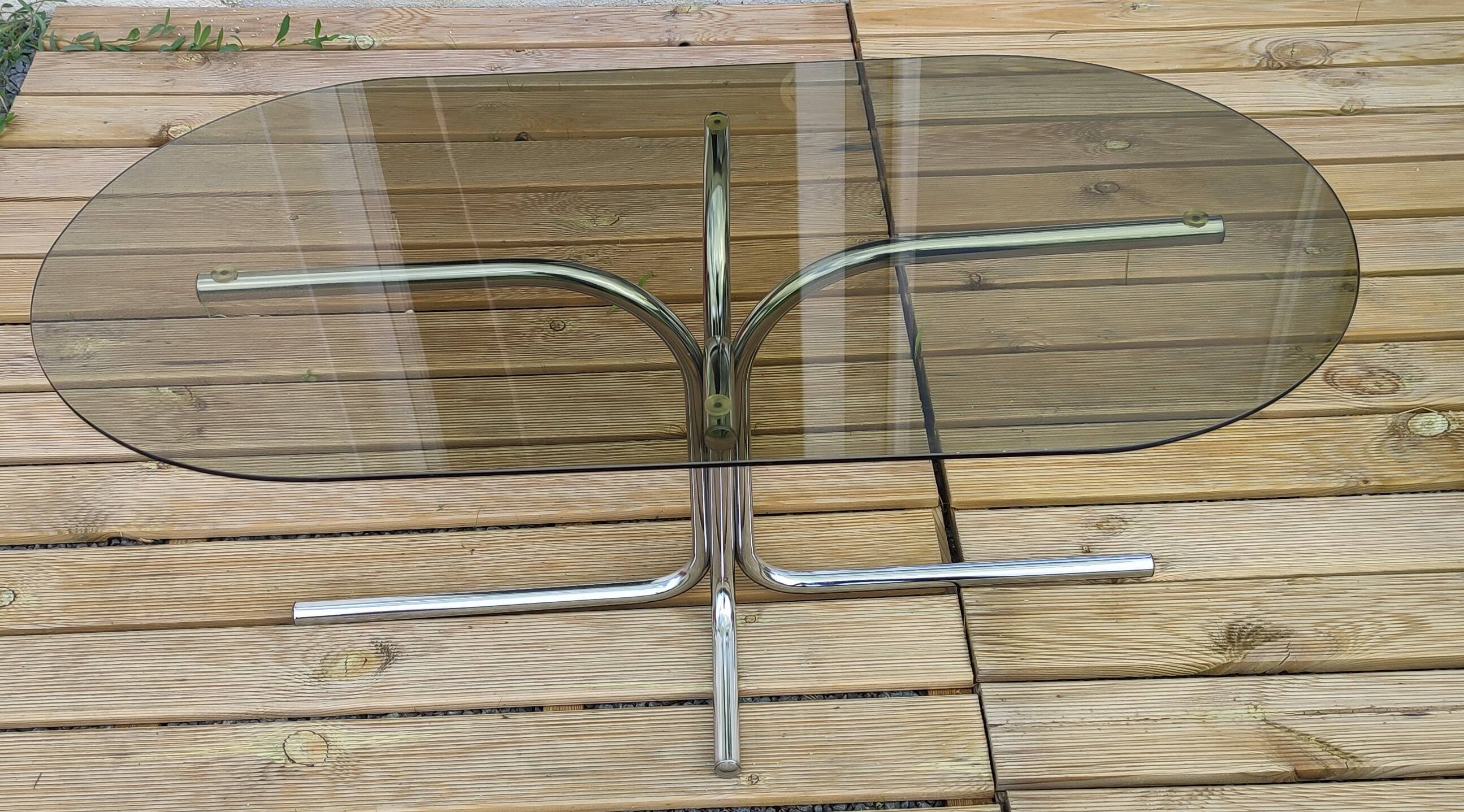 Vintage coffee table with metal tube structure and glass top.