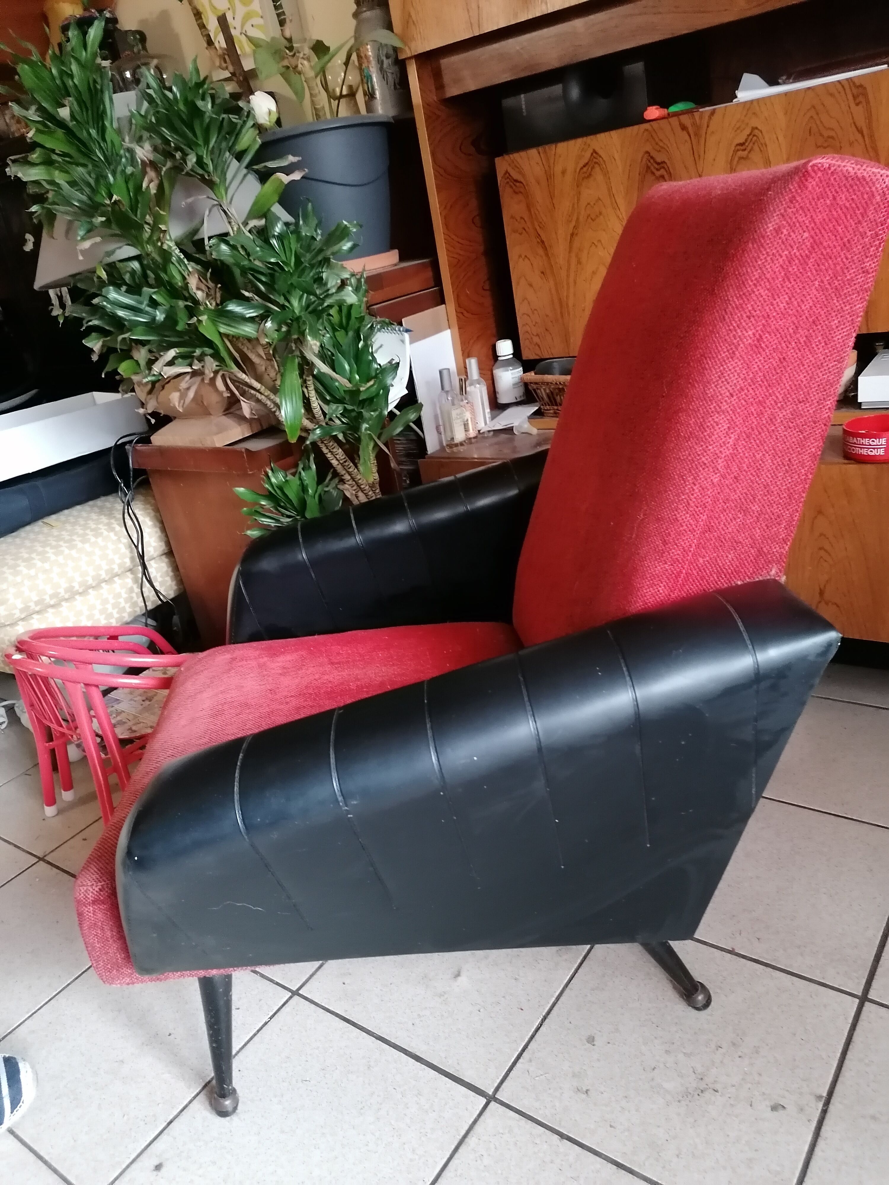 Red and black chair with brass feet