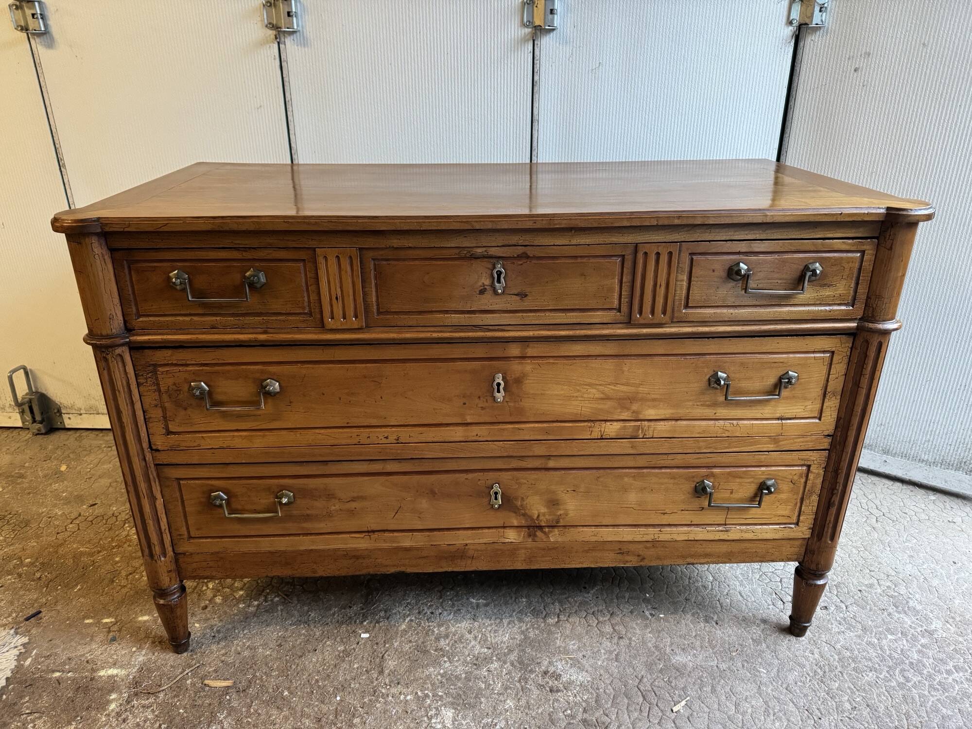 18th-century antique chest of drawers from the Louis XVI period in blonde walnut.