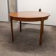 Scandinavian table in round teak with built-in extensions 1960