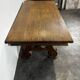 Renaissance-style oak dining table with lyre legs.