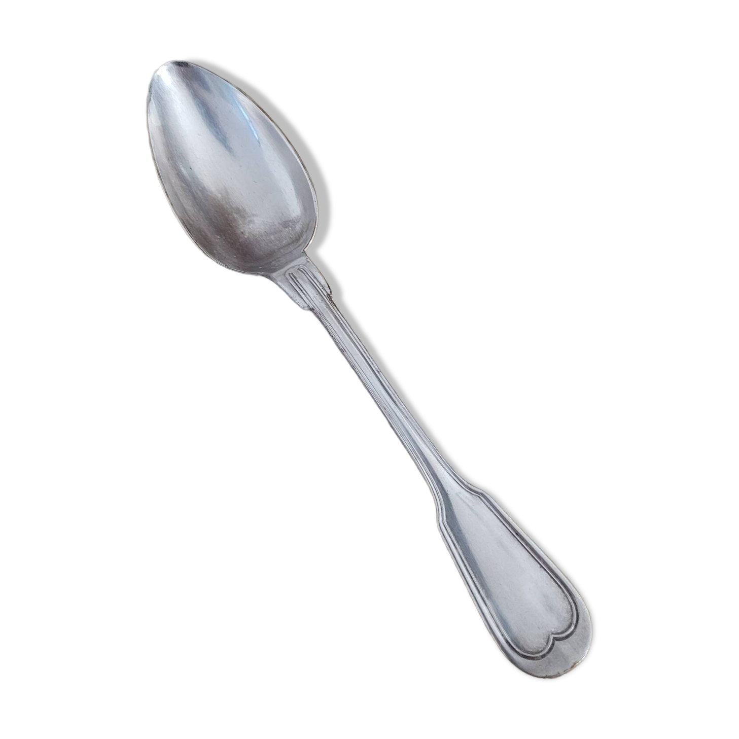 Large silver spoon with net decoration.