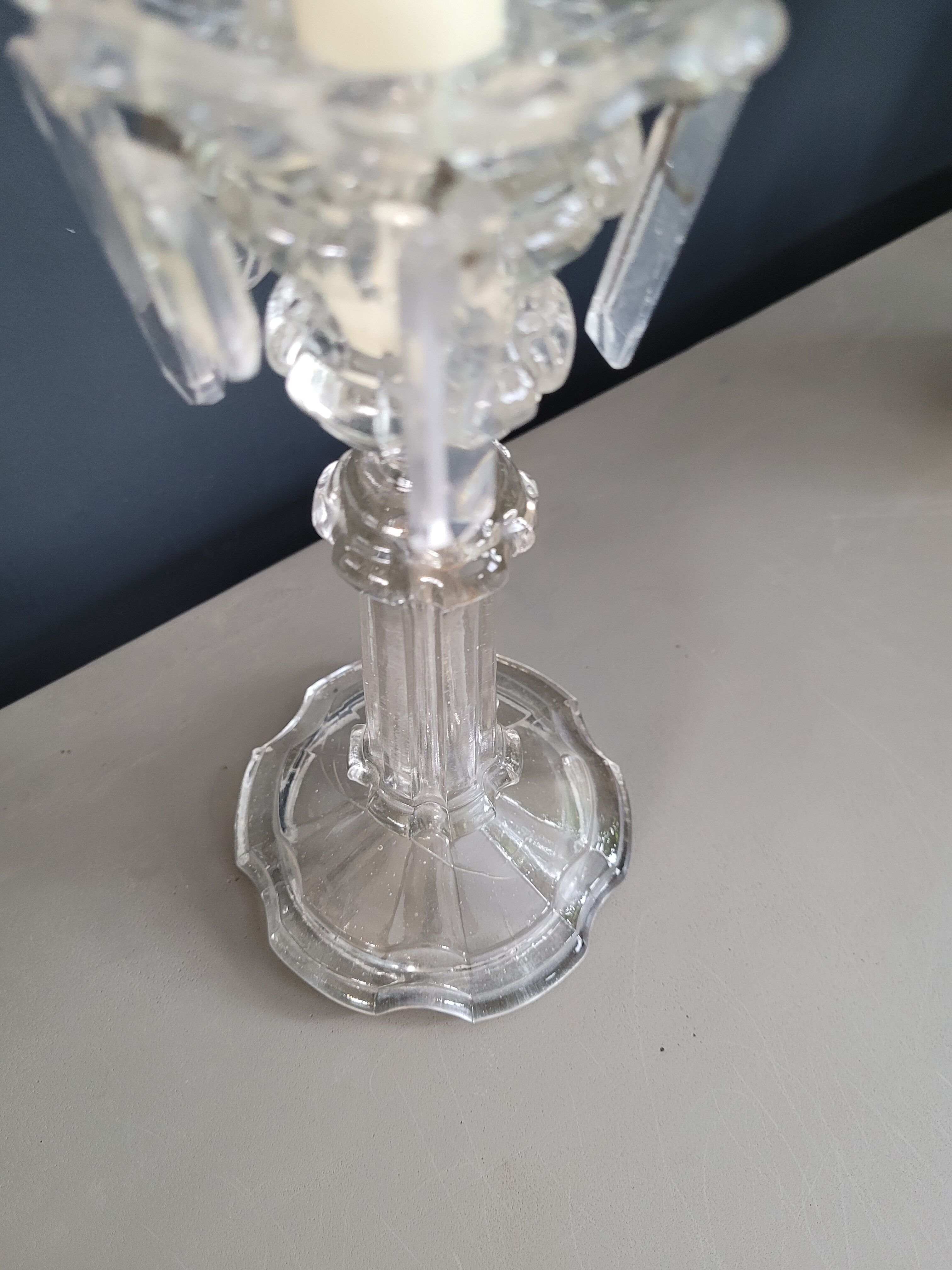 Old candlestick with molded glass stamps