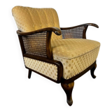 Vintage wooden armchair with rattan weaving.